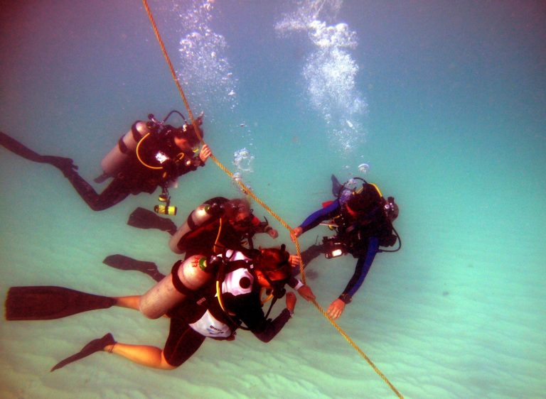 scuba diver with students hazards