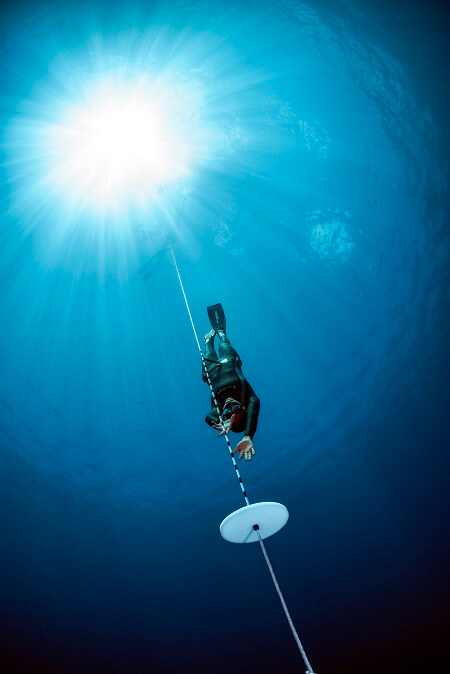 female padi freediver descending the go pro family