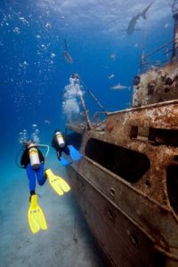 scuba divers on wreck