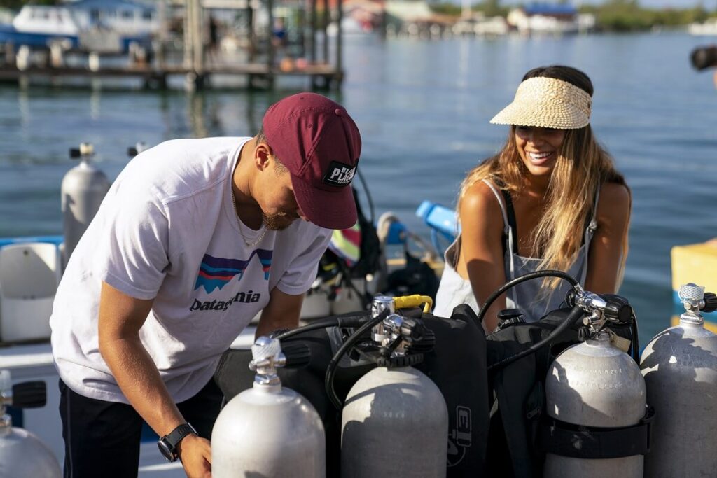 male and female divers on boat